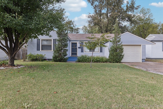 ranch-style house featuring a garage and a front yard