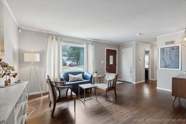 living area featuring dark hardwood / wood-style floors and ornamental molding