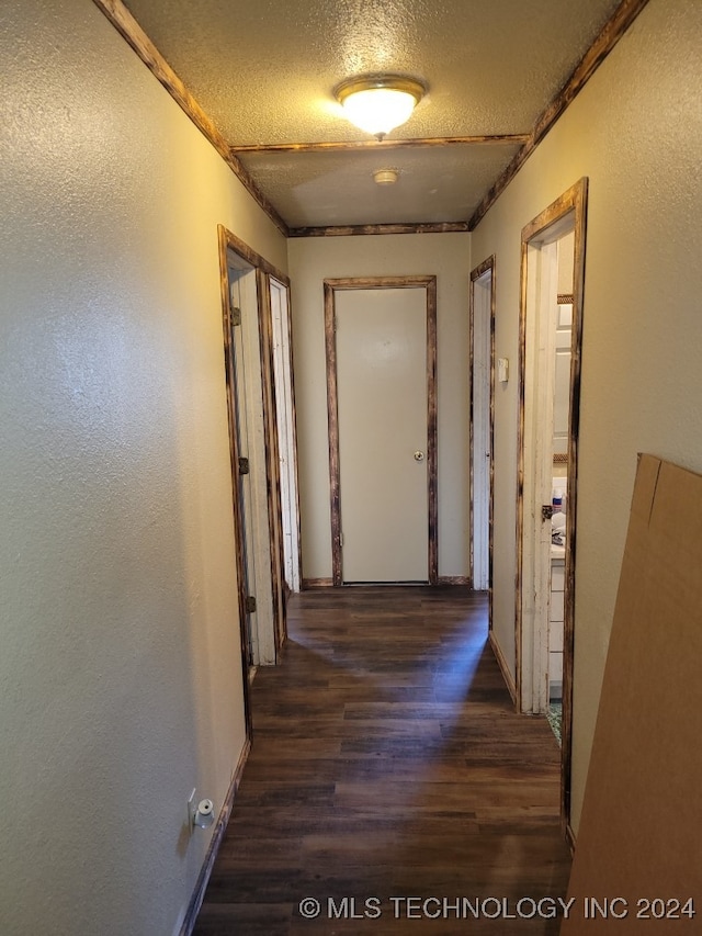 hall featuring dark hardwood / wood-style flooring and a textured ceiling