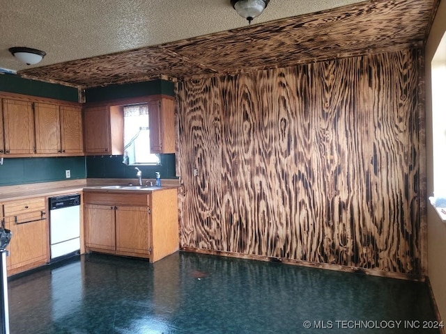 kitchen featuring a textured ceiling, dishwasher, and sink