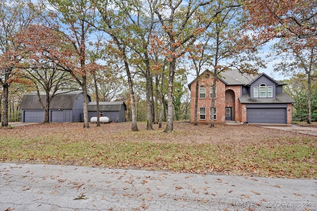 front facade featuring a garage and a storage shed