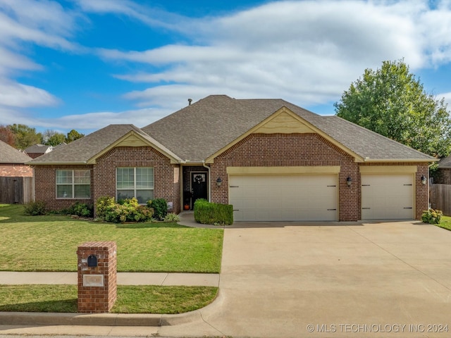 view of front of property featuring a garage and a front lawn