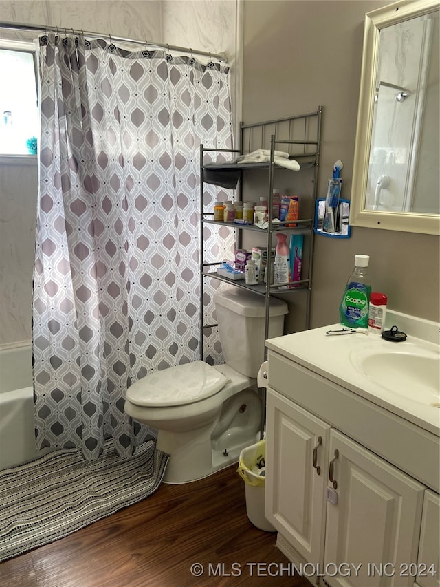 full bathroom featuring shower / bath combo, vanity, hardwood / wood-style flooring, and toilet