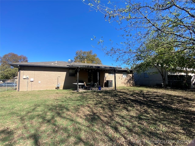 rear view of house with a yard