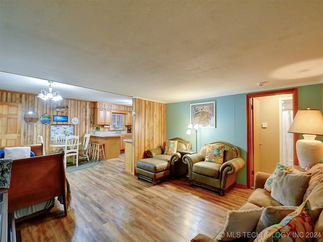 living room with a chandelier and light hardwood / wood-style floors