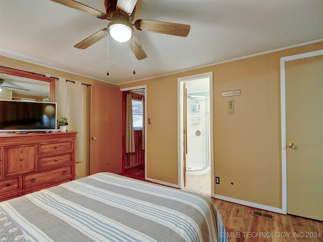 bedroom featuring connected bathroom, ceiling fan, light hardwood / wood-style floors, and ornamental molding