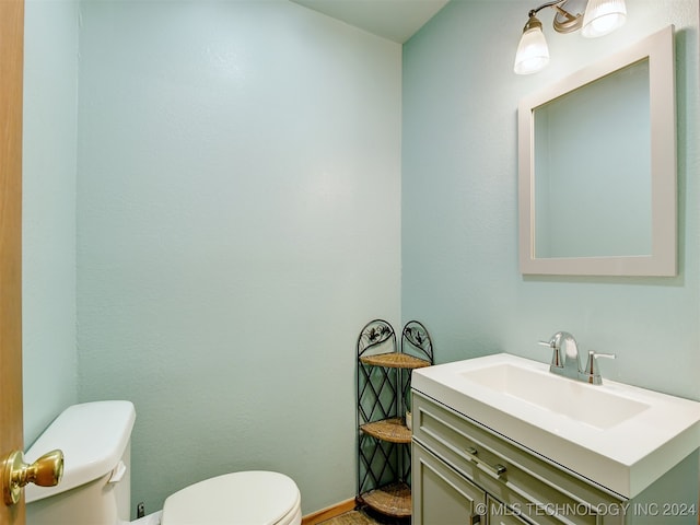 bathroom featuring vanity and toilet