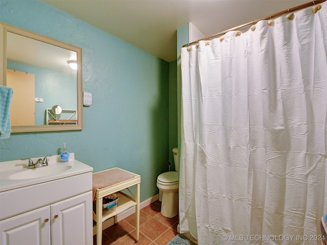 bathroom featuring toilet, vanity, and tile patterned floors