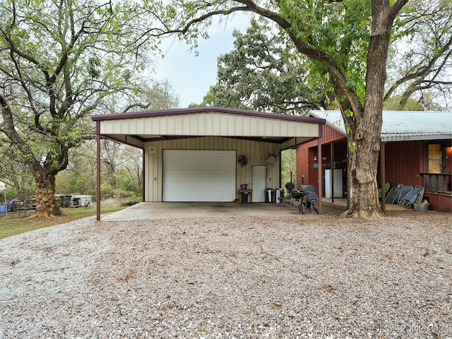 exterior space with a garage and an outbuilding