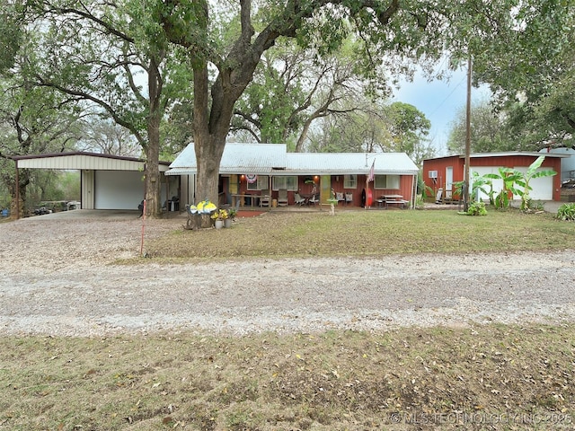 ranch-style house featuring a carport and covered porch