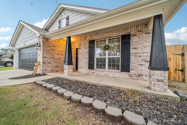 view of front of property with a garage and covered porch