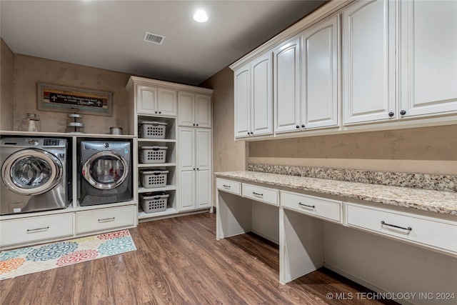 laundry area with cabinets, dark hardwood / wood-style flooring, and washer and clothes dryer