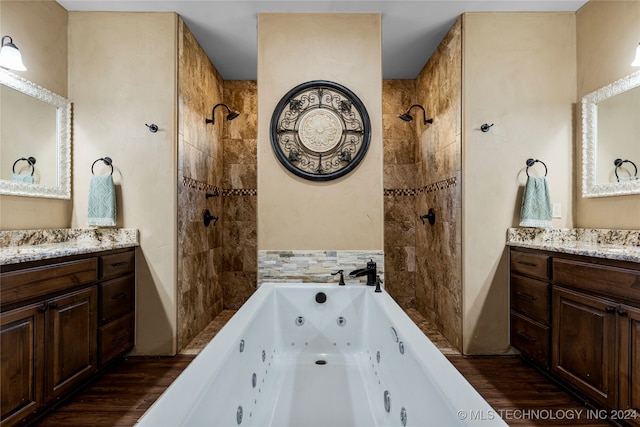 bathroom featuring hardwood / wood-style floors, vanity, and a tub to relax in