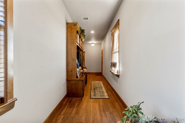 corridor with hardwood / wood-style floors