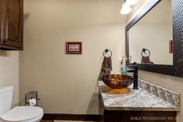 bathroom with vanity and toilet