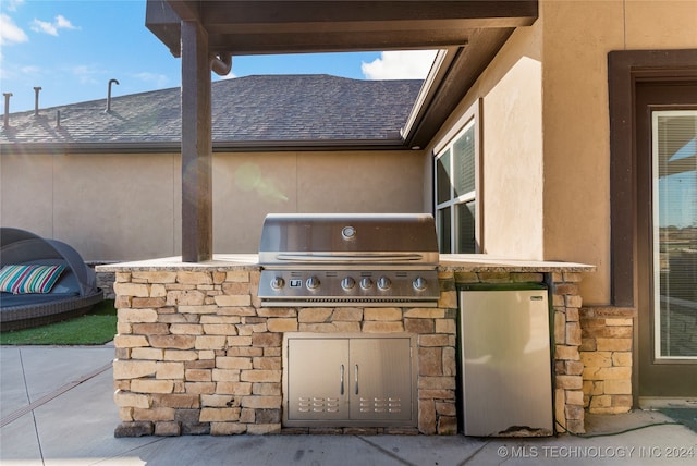 view of patio featuring area for grilling and a grill