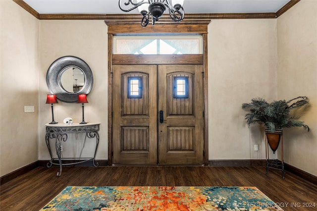 foyer with an inviting chandelier, dark hardwood / wood-style floors, and crown molding