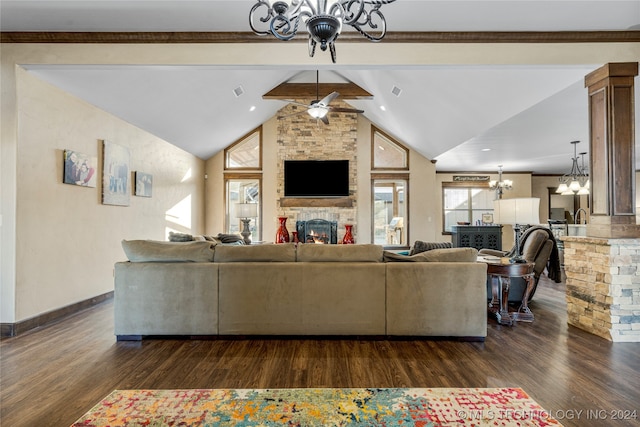 living room with dark hardwood / wood-style flooring, ceiling fan with notable chandelier, lofted ceiling with beams, and a fireplace