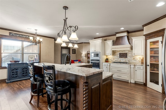 kitchen featuring appliances with stainless steel finishes, custom exhaust hood, decorative light fixtures, dark wood-type flooring, and a large island