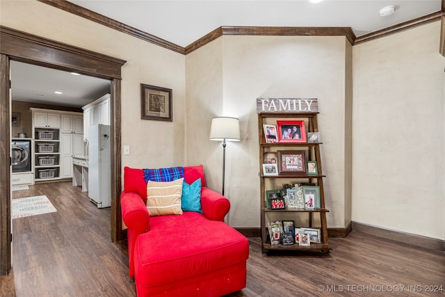 living area with dark wood-type flooring, washer / clothes dryer, and crown molding