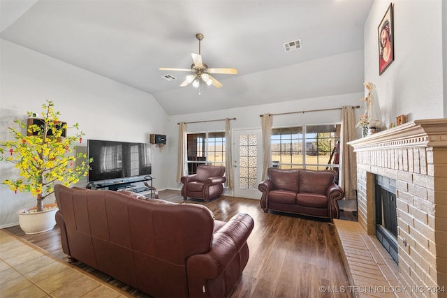 living room with a fireplace, wood-type flooring, ceiling fan, and lofted ceiling