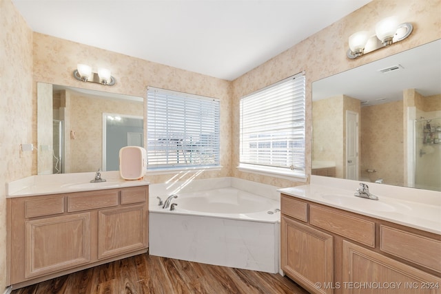 bathroom with vanity, shower with separate bathtub, and hardwood / wood-style flooring