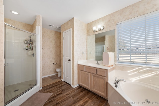 full bathroom featuring hardwood / wood-style flooring, vanity, toilet, and plus walk in shower