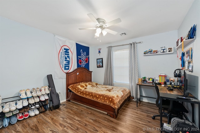 bedroom with hardwood / wood-style floors and ceiling fan