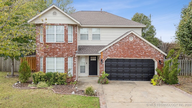 front of property featuring a garage and a front lawn