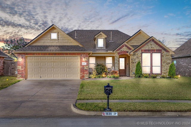 view of front of property featuring a lawn and a garage