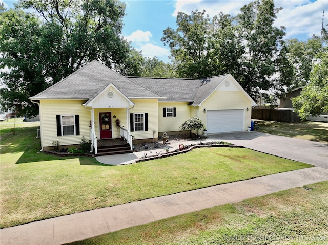 single story home featuring a garage and a front lawn