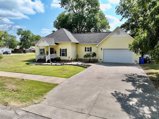 single story home with a front lawn, a garage, and covered porch