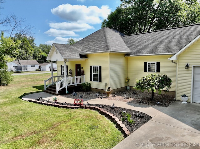 view of front of property with a garage and a front lawn