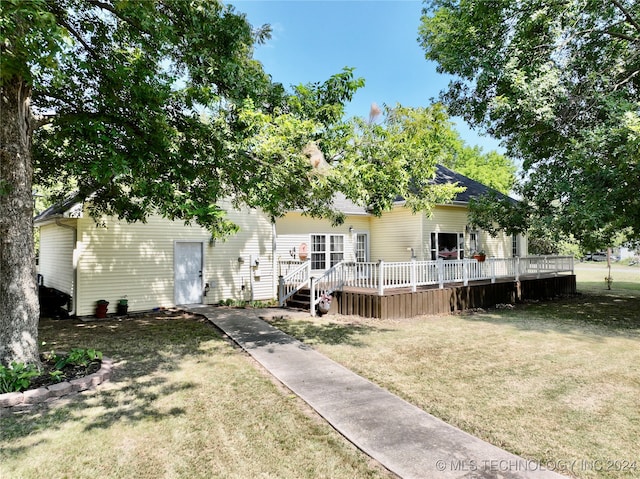 view of front of house with a front yard and a wooden deck