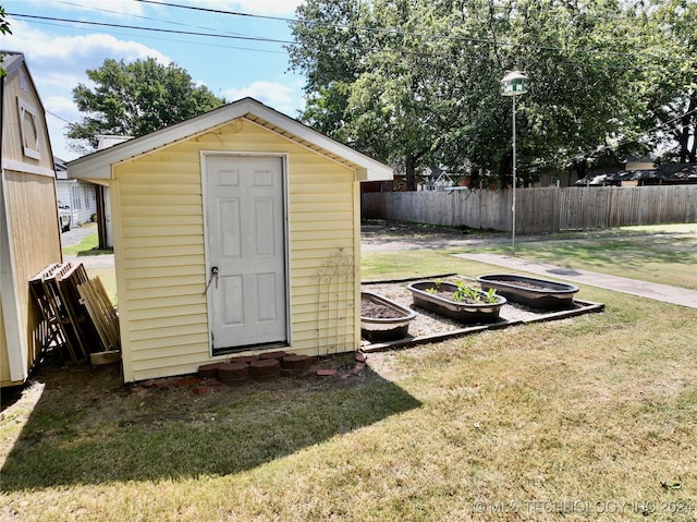 view of outbuilding featuring a lawn