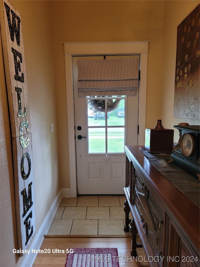 entryway featuring light tile patterned floors