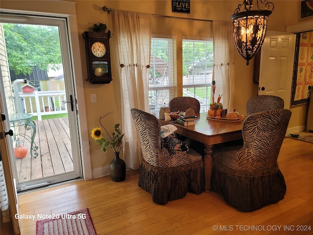 dining space with an inviting chandelier and light wood-type flooring