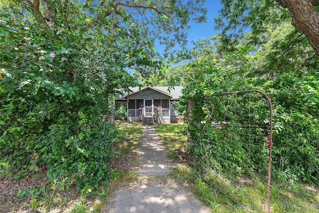 obstructed view of property with a sunroom