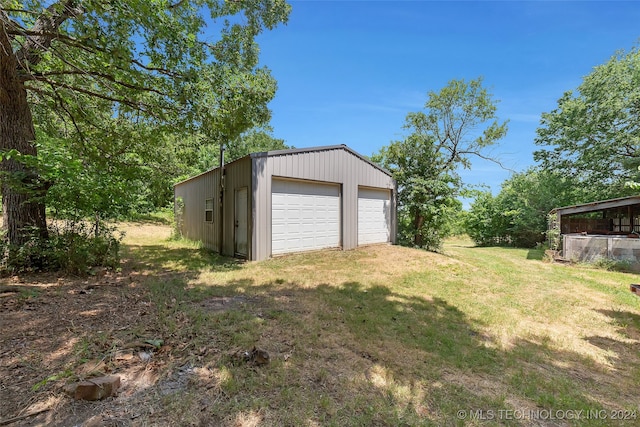 garage featuring a lawn