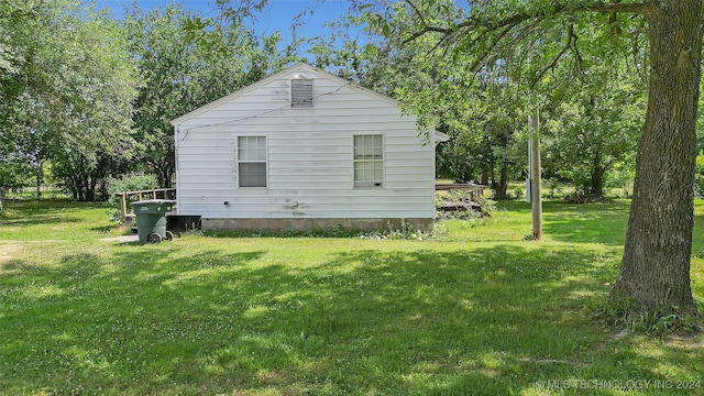 view of property exterior with a lawn