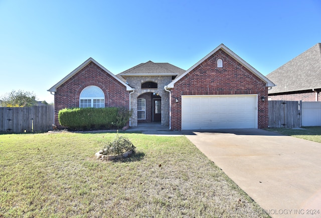 view of front facade with a garage and a front lawn