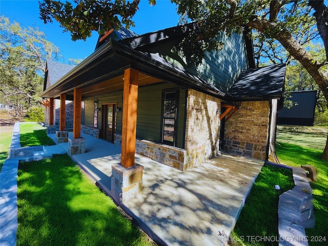 exterior space featuring a lawn and a patio