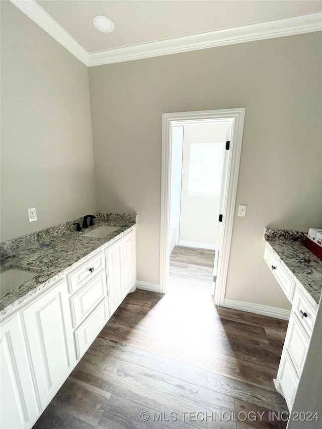 bathroom with hardwood / wood-style floors, vanity, and crown molding