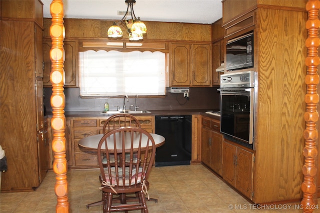 kitchen with black appliances, sink, and decorative light fixtures