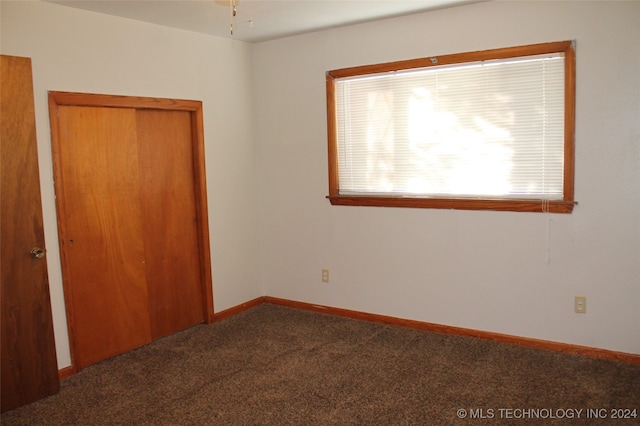 unfurnished bedroom with carpet and a closet