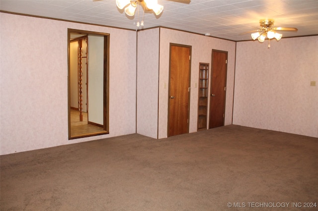 empty room with ceiling fan and carpet floors