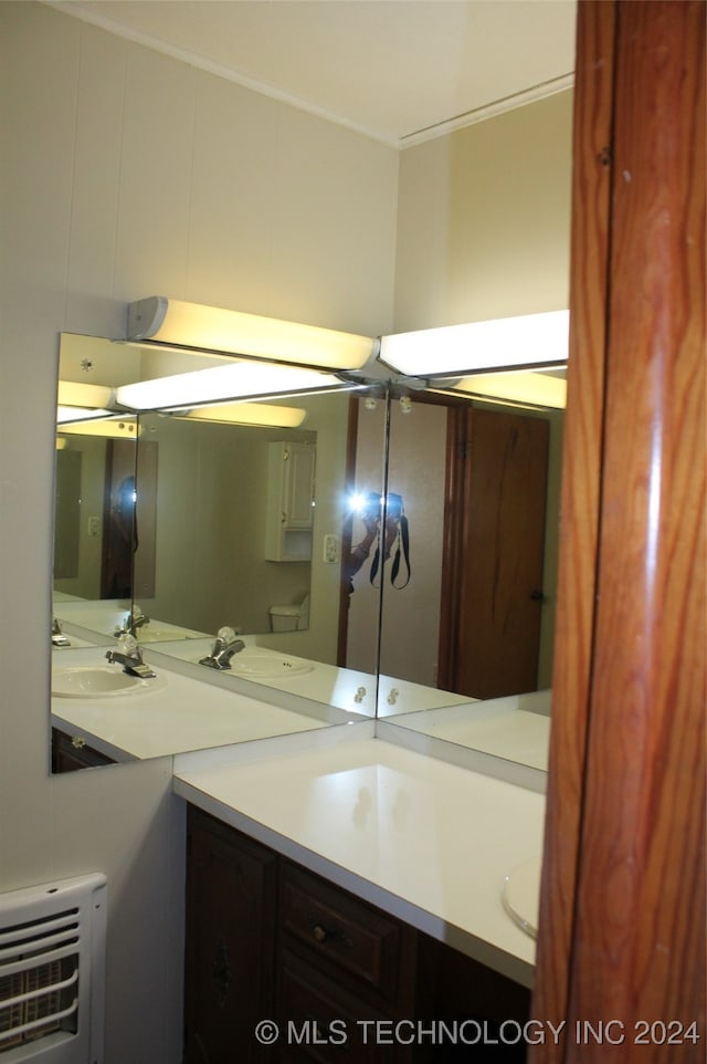 bathroom with vanity and heating unit