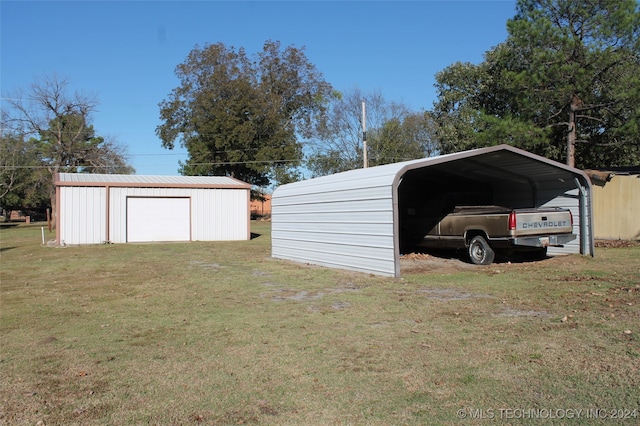 view of outdoor structure featuring a garage, a carport, and a lawn