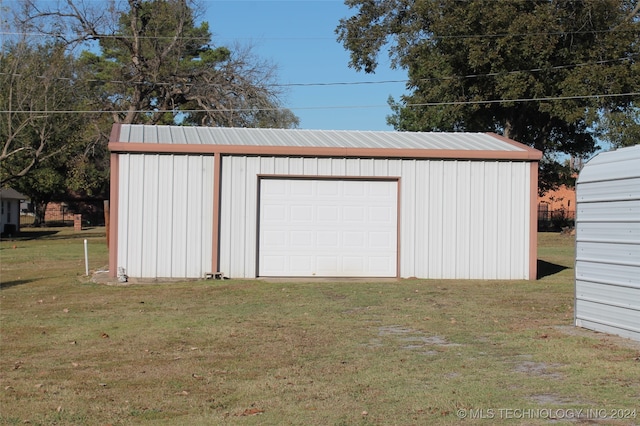 garage featuring a lawn