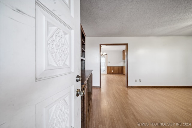 interior space featuring light hardwood / wood-style floors and a textured ceiling